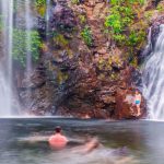 people swimming in waterfall in Litchfield national park