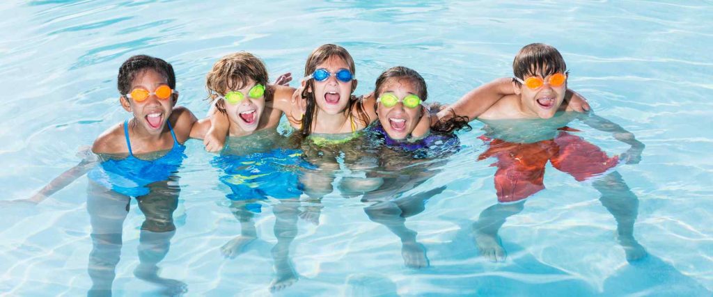 Five kids swimming in a pool