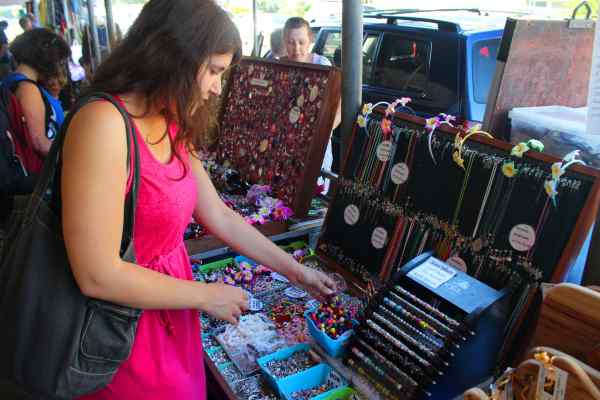 Someone browsing the jewellery at Parap Village Markets